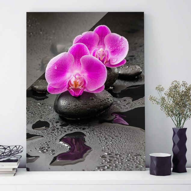 Magnettafel Glas Pinke Orchideenblüten auf Steinen mit Tropfen