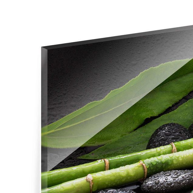 Glasbild - Grüner Bambus mit Orchideenblüte - Panorama