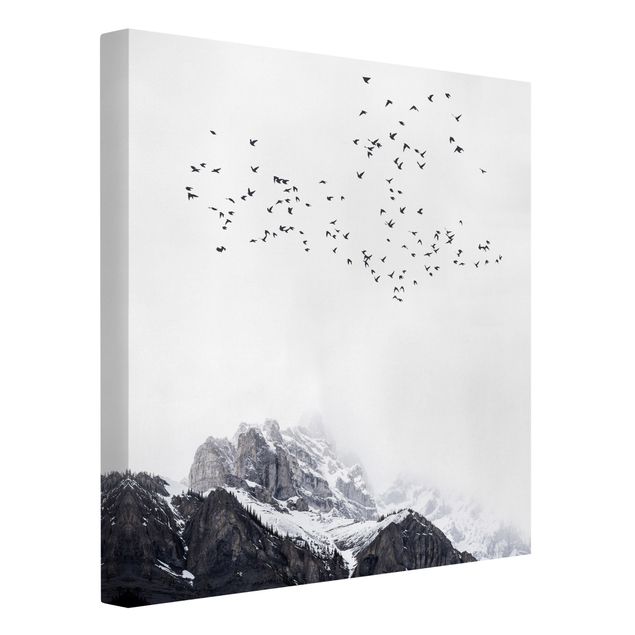Leinwandbild - Vogelschwarm vor Bergen Schwarz Weiß - Quadrat 1:1