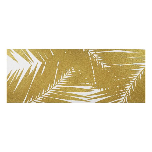 Glasbild - Blick durch goldene Palmenblätter - Panorama