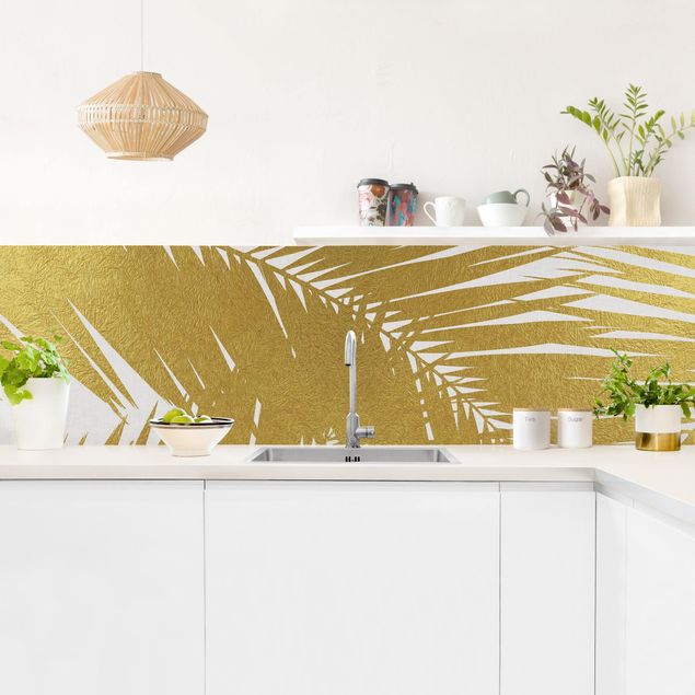 Küchenrückwand - Blick durch goldene Palmenblätter